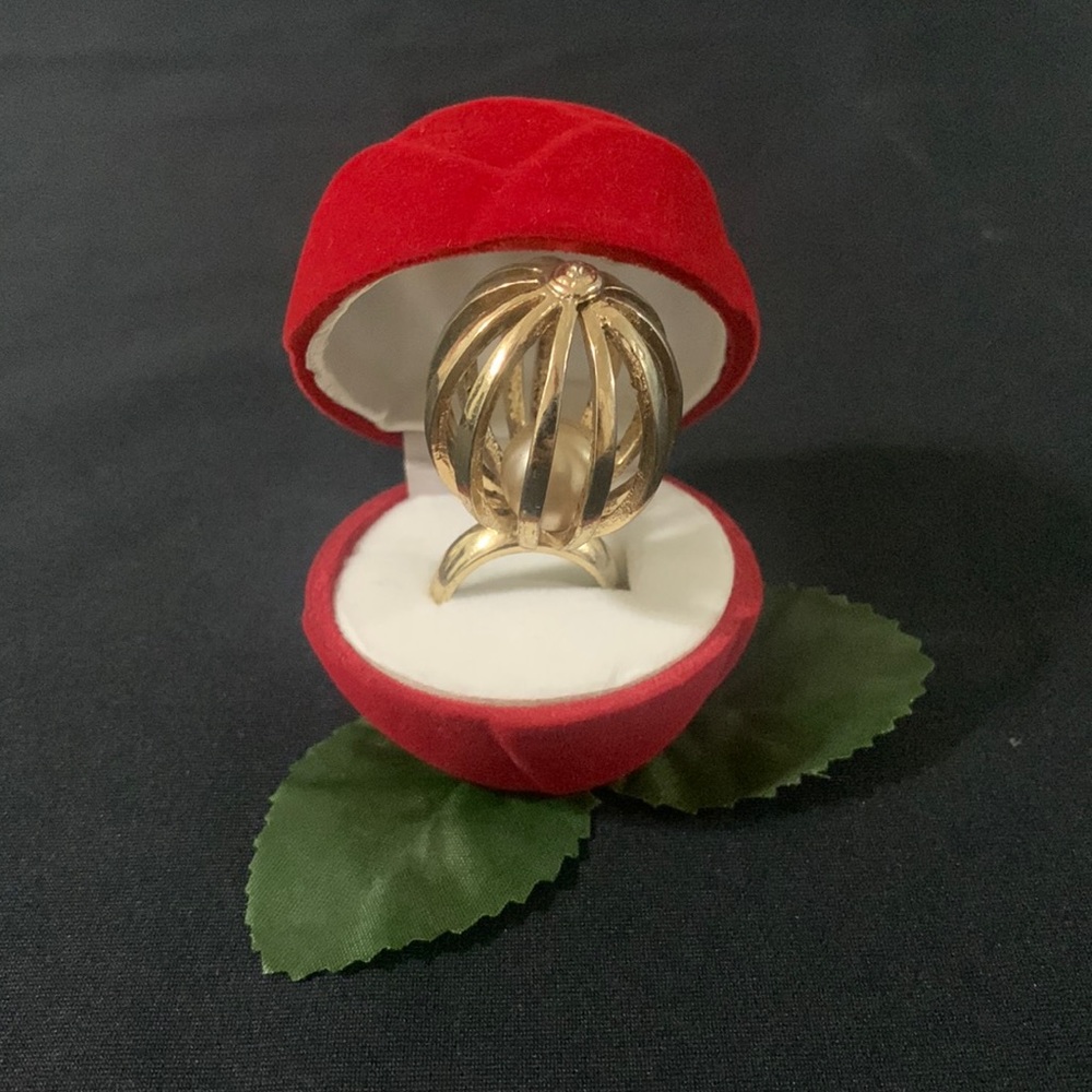 Gold ring cage with pearl inside